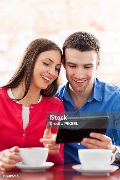 Couple Using Digital Tablet In Cafe Stock Photo - Download Image Now - Adult, Adults Only, Beautiful People