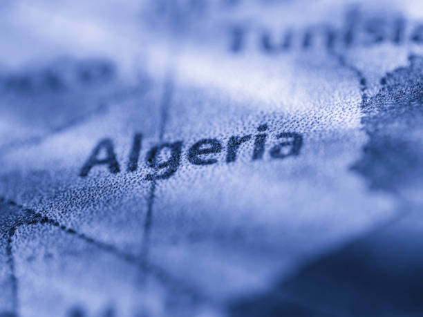 Red push pin pointing at France on plastic globe, plan for travelling concept