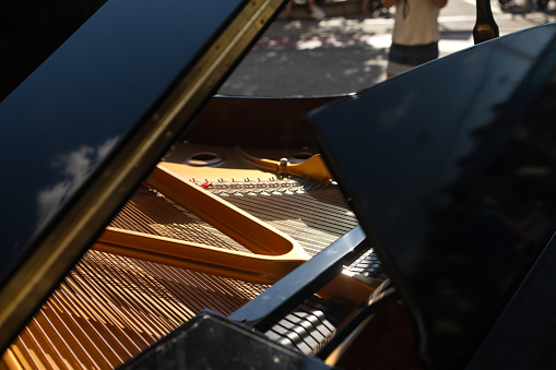 black Piano is inside, strings closeup, nobody, outdoor