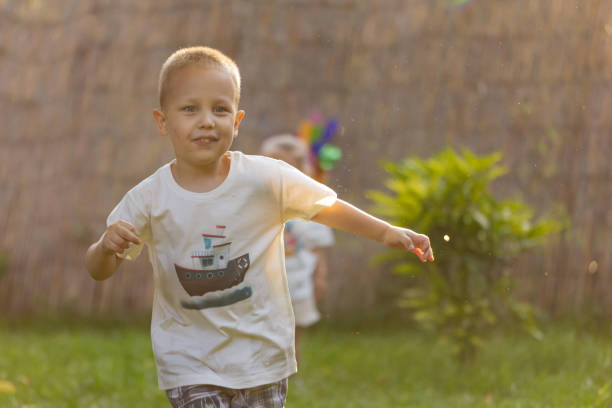 The simple pleasure of a child's playtime: a little boy running in a green paradise.