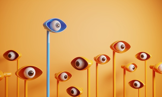 Abstract digital generated eyes looking around and the blue one standing out from the crowd. (3d render)