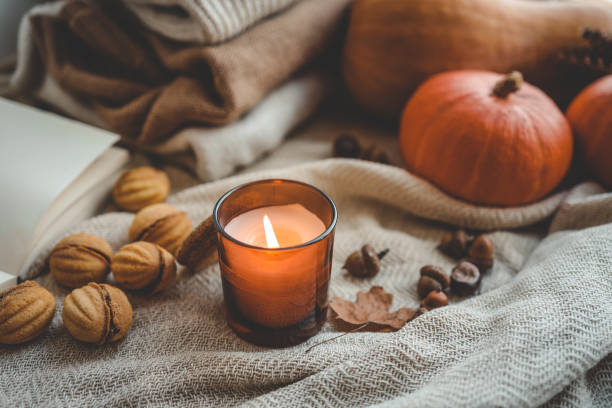 istock Burning candle in a cozy autumn interior 1666164056