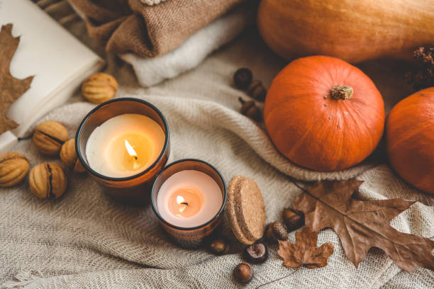 istock Two burning candles in the autumn interior 1666164060
