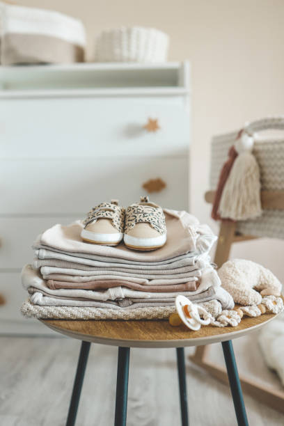 istock A stack of children's things on a wooden table in a children's interior 1666168375