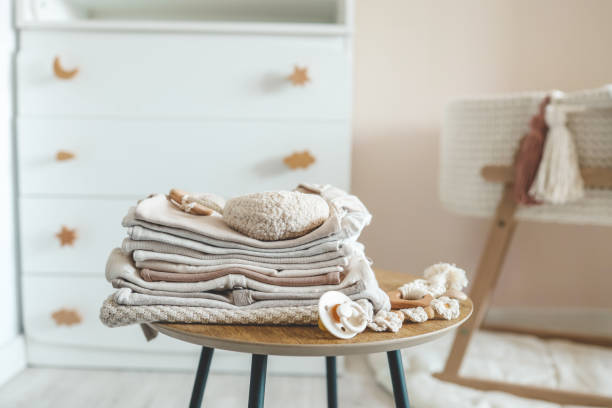 istock A stack of children's things on a wooden table in a children's interior 1666168483
