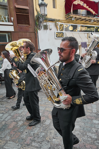 Jerez de la Frontera, Spain - September 7, 2023: Group of men dressed in formal clothes playing the trombone in the street.
