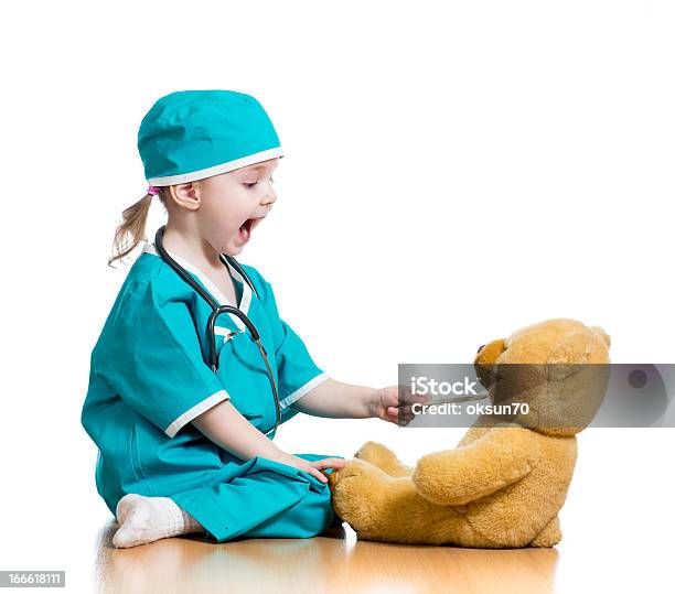 Adorable Child Dressed As Doctor Playing With Toy Stock Photo - Download Image Now - Doctor, Pediatrician, Child