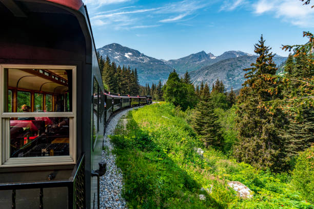 White Pass Summit excursion tour train in the mountains, Alaska, USA. White Pass Summit excursion tour train, Alaska, USA. alaska gold rush stock pictures, royalty-free photos & images