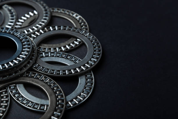 Lot of metal bearings on a dark background. stock photo