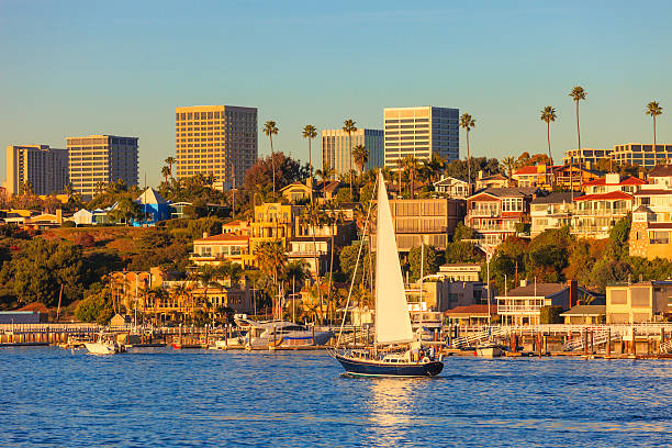 Newport Beach skyline and houses Newport Beach houses with the Fashion Island skyline in the background newport beach california stock pictures, royalty-free photos & images