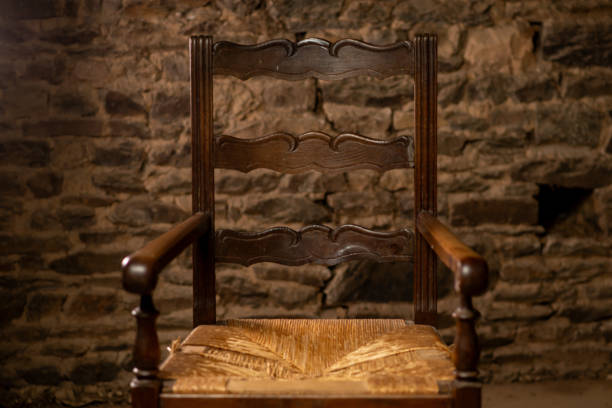 istock Empty antique chair on the background of a stone wall. 1666206603
