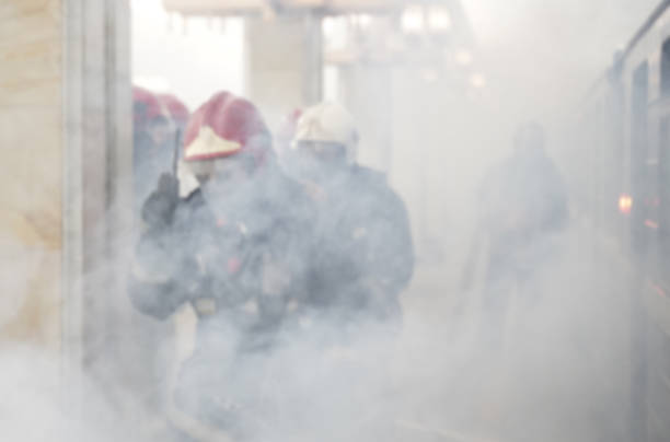 Rescue service concept. Background photo. Rescuers firefighters go into the smoke in the subway. The image is blurry.
