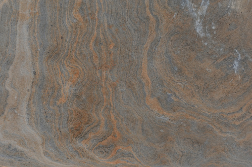 Metamorphic rock abstract background textured foliation stone surface.