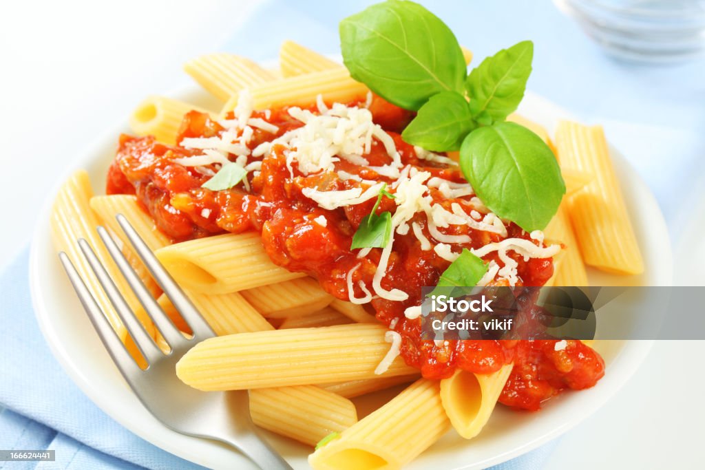 Penne with meat tomato sauce Penne pasta with meat-based tomato sauce and cheese Basil Stock Photo