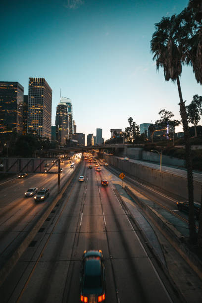 Traffic in Los Angeles Downtown at night. Office buildings illuminated.