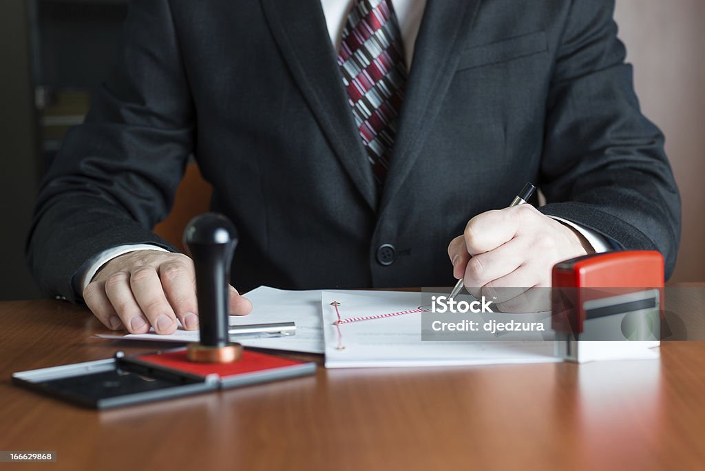 Notary Public in his office signed a contract Notary Public in his office signing a contract Notary Stock Photo