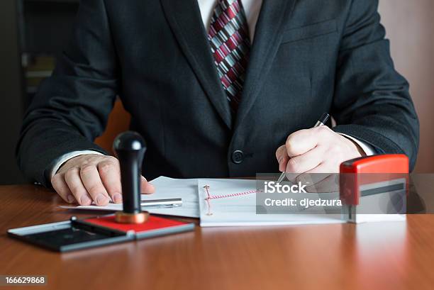 Notary Public In His Office Signed A Contract Stock Photo - Download Image Now - Notary, Rubber Stamp, Office