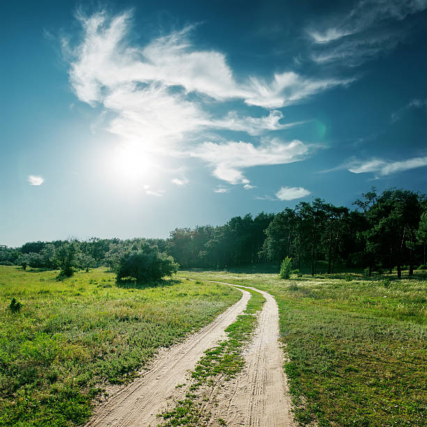 istock sun and clouds over road to wood 166631972