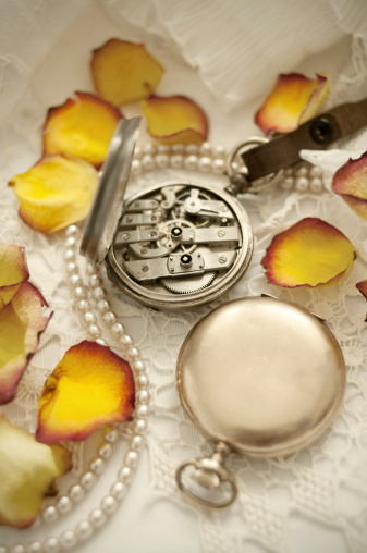 Still life with old-fashioned watches and rose petals