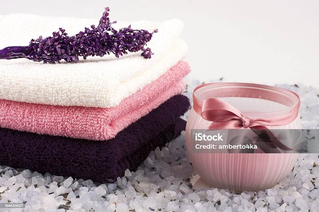 spa towels and salt crystals composition with bath towels, salt crystals and candle Aromatherapy Stock Photo