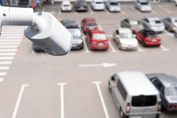 istock Technician installed IP CCTV camera hi-technology for look security area of work in car parking lot show signage with security cars park in area 1666349479