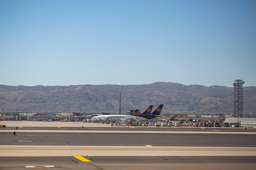 A group of  United Parcel Service cargo aircrafts parked at Phoenix Sky Harbor International Airport in April 2022.