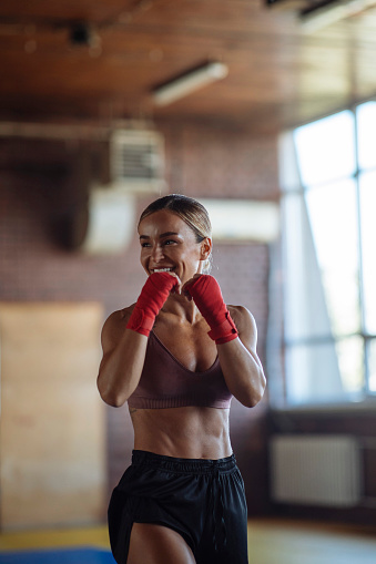 A fit young woman enjoys her workout with a smile on her face