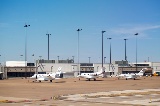 3 private aircrafts: Cessna 560XL Citation Excel with registration N803JS, Embraer EMB-505 Phenom 300 with registration N386QS and Cessna 525B Citation CJ3 parked at Dallas/Fort Worth International Airport in March 2022
