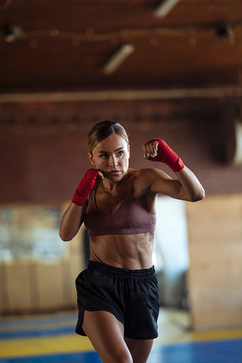This fit young woman is honing her boxing techniques at the gym