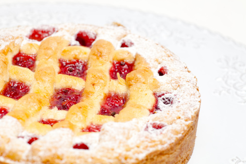 Austrian linzer torte delicious cake. Linzer Torte is a crumbly pastry made of flour, butter, egg yolks, lemon zest, cinnamon and lemon juice, and hazelnuts, or walnuts or almonds, covered with a filling of redcurrant jam.