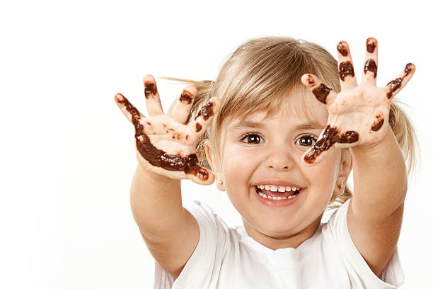Small girl with chocolate Small girl with chocolate smeared her fingers. chocolate fingers stock pictures, royalty-free photos & images