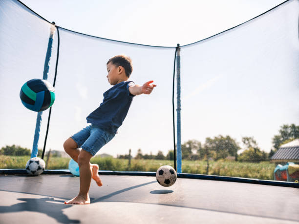 istock Mixed race boy enjoying trampoline  in summer 1666405256