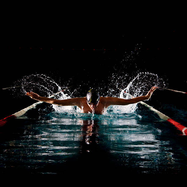 istock Man swimming butterfly in pool 166640670