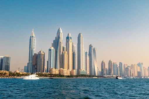 Dubai Marina skyline as seen from a boat sailing on the Persian Gulf.