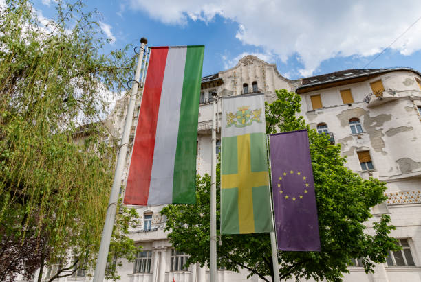 Flag of the Hungary waving in the wind on the Hungarian Parliament Building in Budapest, close-up on sunny day, Hungary