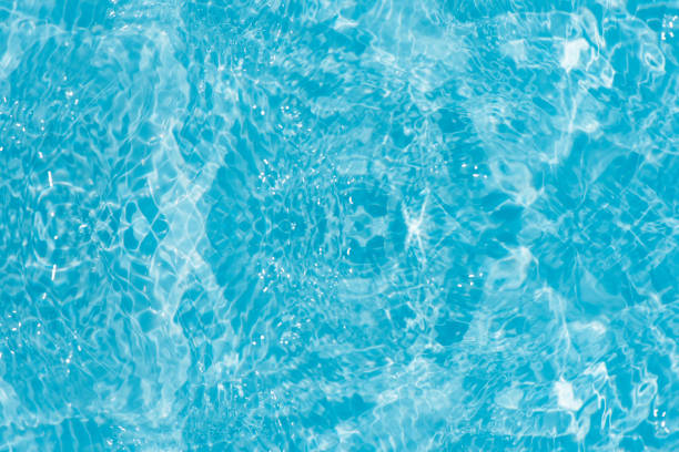 istock Blue water with ripples on the surface. Defocus blurred transparent blue colored clear calm water surface texture with splashes and bubbles. Water waves with shining pattern texture background. 1666518707