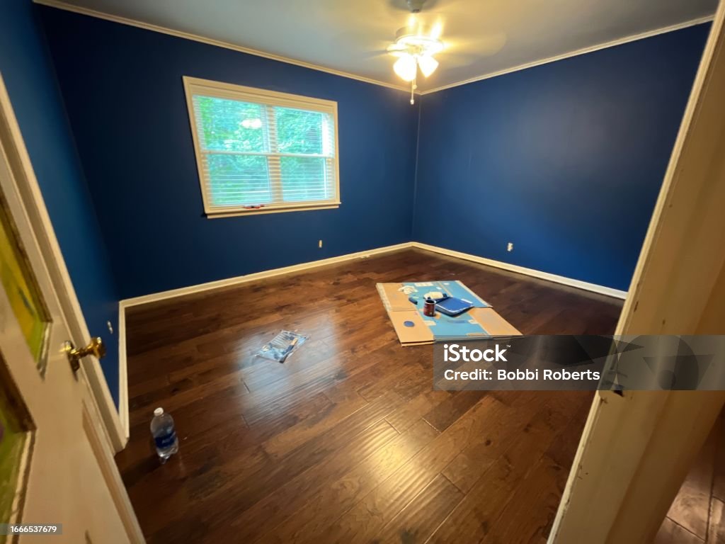 Blue Painted Bedroom Freshly painted, vibrant blue bedroom walls. Bedroom Stock Photo