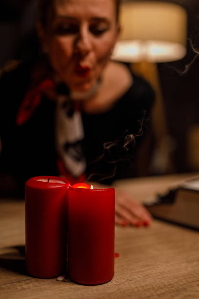 istock Woman blowing out candles on her desk before leaving 1666556650