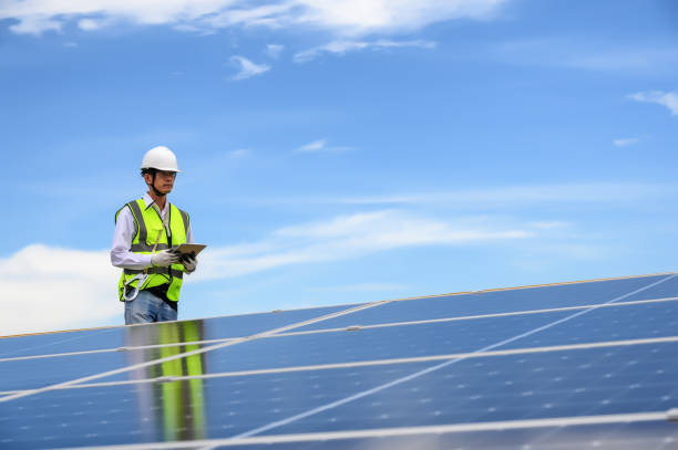 istock Engineer Inspector Quality in Solar Roof Panel Installation, Sustainable Photovoltaic Work for Factory Buildings. Natural Energy Sources Infrastructure Development in Efficiency. 1666556677
