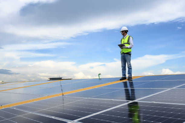 istock Engineer Inspector Quality in Solar Roof Panel Installation, Sustainable Photovoltaic Work for Factory Buildings. Natural Energy Sources Infrastructure Development in Efficiency. 1666556678