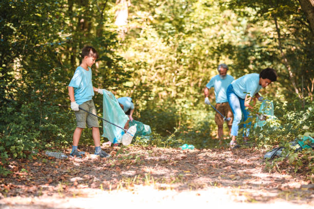 istock Adults and Boy Using Pickup Sticks to Get rid of Garbage 1666581063