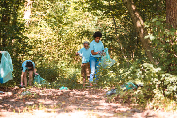 istock Active Adults Putting Trash Away in Blue Plastic Bags 1666581066