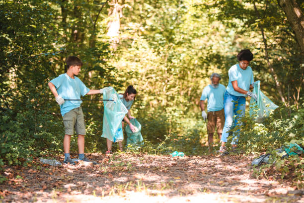 istock Blue Uniformed Responsible Group of People Putting Away Trash 1666581067