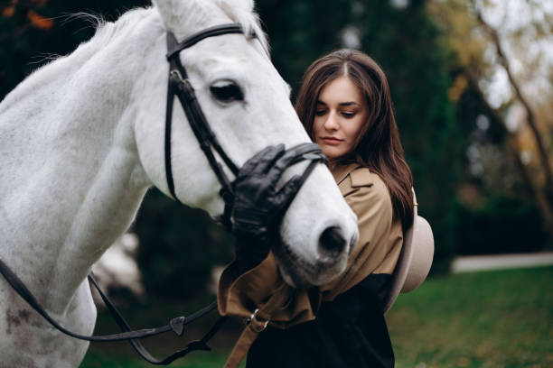 istock A young woman hugs a white horse. 1666644909