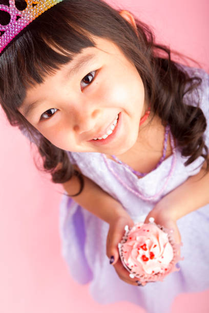 istock Young girl holding a cupcake 166669262