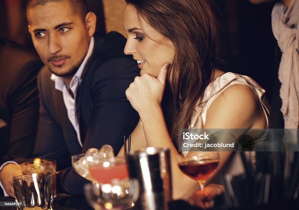 Gorgeous Woman with Boyfriend at the Bar Gorgeous woman sitting at the bar with her handsome boyfriend Adult Stock Photo