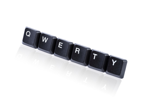 Computer keys with a beautiful reflection isolated on white background forming the word Qwerty. QWERTY is the most common modern-day keyboard layout. The name comes from the first six keys appearing on the top left letter row of the keyboard and read from left to right. Reflection added in post-processing. Large copy space for your TEXT. English keyboard.