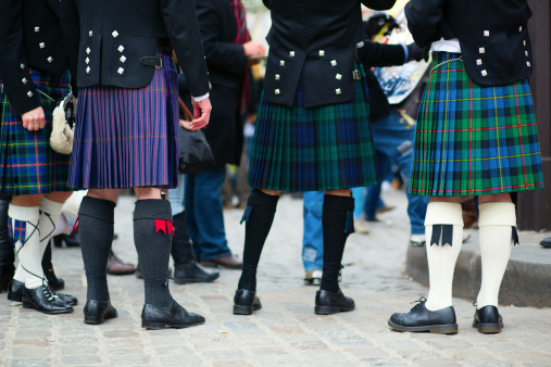 Waist down view of a group of men in traditional kilts