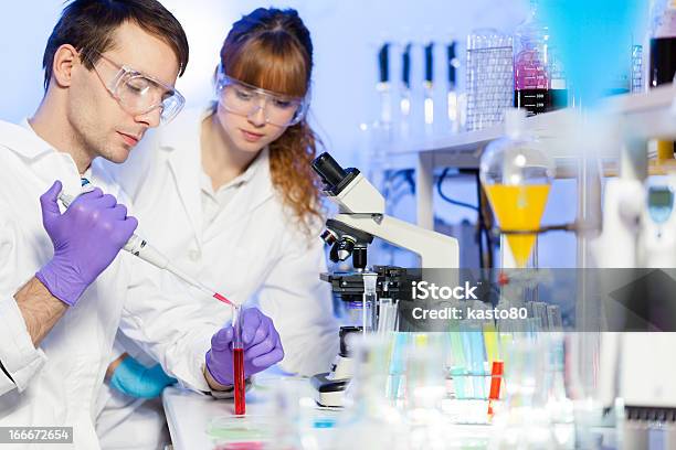 Health Care Professionals Testing Chemicals In A Lab Stock Photo - Download Image Now