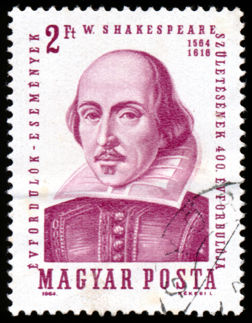 Engraving of the famous English Elizabethan playwright William Shakespeare, 1564-1616, on a postage stamp from Hungary. Isolated on black.